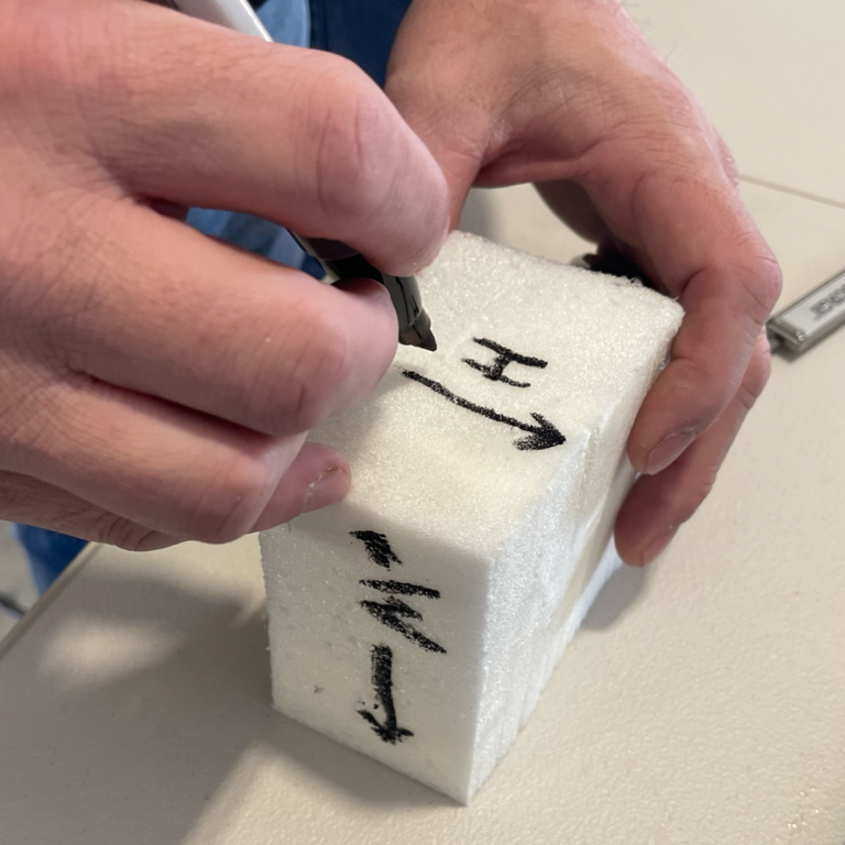 Mark 3 sides of the block for length, width, and height.