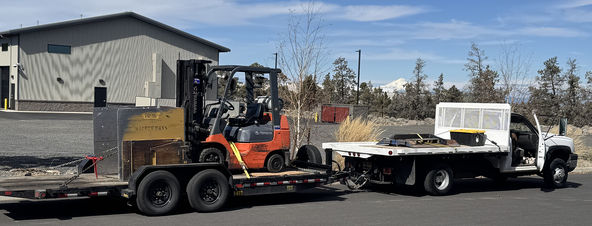 5-star service: a tractor on a flatbed truck ready for delivery