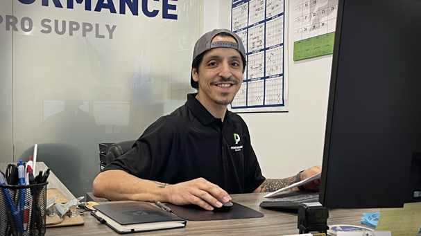 Daniel smiling at the front desk at Performance Pro Supply in Phoenix